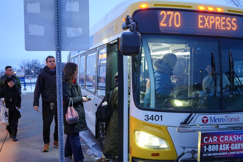 Customers board a Route 270 bus. 